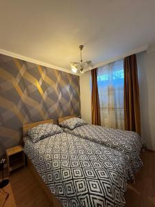 Ένα ή περισσότερα κρεβάτια σε δωμάτιο στο NIKA Apartman