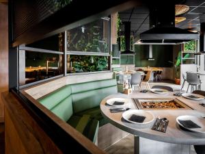 a dining room with a table with dishes on it at Farmhouse in Limburg with Private Sauna in Roggel