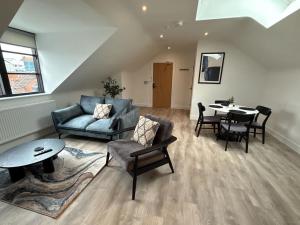 a living room with a couch and a table at Luxury 1 bed - 7 Queen Street Abingdon - Centrally located parking subject to availability in Abingdon