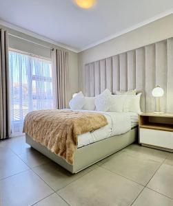 a bedroom with a large bed and a window at Sandton Nest in Johannesburg +21 photos