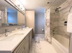 a bathroom with two sinks and a tub and a shower at Plano Family Haven Cozy & Close To Everything! in Plano