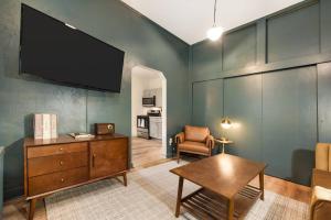 a living room with a flat screen tv on the wall at Lawrenceville Charm Free Park in Pittsburgh