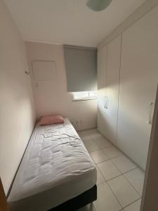 een kleine kamer met een bed en een raam bij Apartamento Pedreira in Belém
