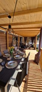 a table and chairs on a deck with a table and chairs at Mobile home K in Biograd na Moru +32 photos