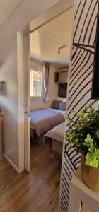 a small bedroom with two beds and a staircase at Mobile home K in Biograd na Moru