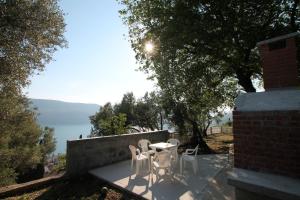 a table and chairs on a patio with a view at Apartment Bayer in Herceg-Novi