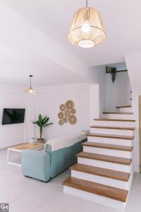 a staircase in a living room with a blue couch at GMhouse in Perdika