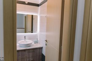 a bathroom with a sink and a mirror at GMhouse in Perdika +23 photos