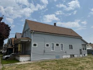 a gray house with a brown roof at Downtown Golden Stairs in Buffalo