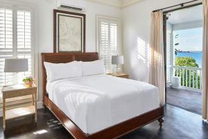 a bedroom with a bed with a view of the ocean at French Leave Resort, Autograph Collection in Governorʼs Harbour