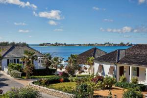 a row of houses with a lake in the background at French Leave Resort, Autograph Collection in Governorʼs Harbour