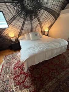 a bed in a room with a round ceiling at The Gaslamp Bed and Breakfast in Provincetown +14 photos