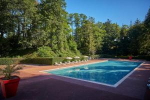 a swimming pool with chairs in a yard at Mobil home paisible in Saint-Chéron +16 photos