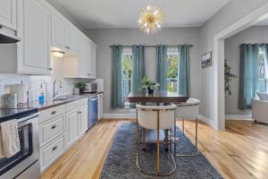 a kitchen with white cabinets and a table with a stool at 1 Bedroom Home in Downtown Lake Charles La in Lake Charles