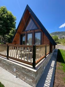a log cabin with a porch and a balcony at Grlo Sokolovo A-Frame Cottage - Mountain Retreat near Podgorica in Korita
