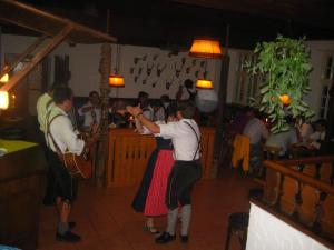 a couple of people dancing in a bar at Sporthotel Schönau am Königssee in Schönau am Königssee