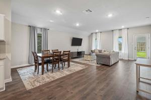 a living room with a table and chairs and a couch at 4 Bedroom home with Hot Tub in Lake Charles La in Lake Charles