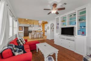 a living room with a red couch and a tv at Waterfront 3 Bedroom Home in Prien