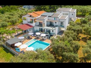 an aerial view of a house with a swimming pool at Olive Roots in Skala Rachoniou