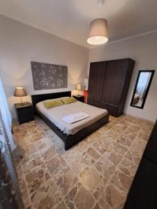 a bedroom with a large bed and a stone floor at Vistamare in Marina di Cecina
