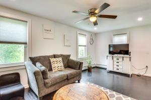 a living room with a couch and a ceiling fan at Ski, Hike and Fish Pet-Friendly Home in Saylorsburg in Saylorsburg