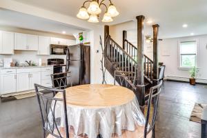a kitchen with a table and a refrigerator at Ski, Hike and Fish Pet-Friendly Home in Saylorsburg in Saylorsburg