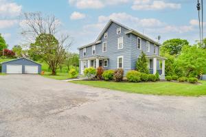 a large blue house with a driveway at Ski, Hike and Fish Pet-Friendly Home in Saylorsburg in Saylorsburg