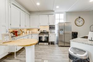 a kitchen with white cabinets and stainless steel appliances at Unique Church Turned Family Retreat Relax and Enjoy in Alliance