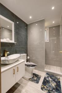 a bathroom with a sink and a toilet and a shower at City Pearl in Kos Town +13 photos