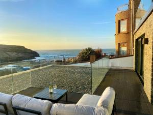 a living room with a view of the ocean at The North Cove, 20m to the Sea, Modern Studio Apartment in Portrush