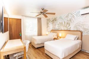 Ένα ή περισσότερα κρεβάτια σε δωμάτιο στο Hotel Cocoplum Beach