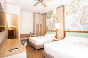 Ένα ή περισσότερα κρεβάτια σε δωμάτιο στο Hotel Cocoplum Beach