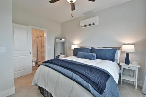 a bedroom with a large bed with blue pillows at Waterfront Retreat in Knoxville