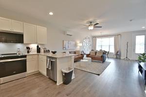 an open kitchen and living room with a couch at Waterfront Retreat in Knoxville
