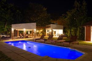 a swimming pool in a yard at night at El Refugio Lodge in Corrientes
