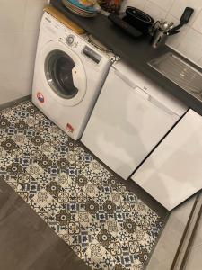 a washer and dryer on a tile floor in a kitchen at habitat la DHUYS in Montreuil