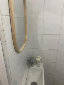 a bathroom with a toilet and a mirror on the wall at habitat la DHUYS in Montreuil +10 photos