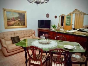 a living room with a table and a couch at Miky M House in Venosa