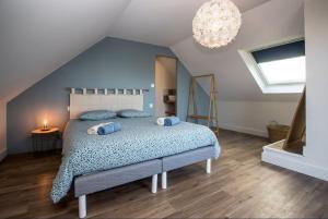 a bedroom with a large bed in a attic at Ti Poulfoen in Plouescat