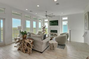 a living room with a couch and chairs and a fireplace at BeachHouse Bliss in Padre Island