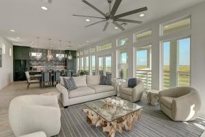 a living room with a couch and chairs and a table at BeachHouse Bliss in Padre Island