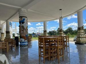 a room with a table and chairs and a large vase at Hotel Palace in La Concordia