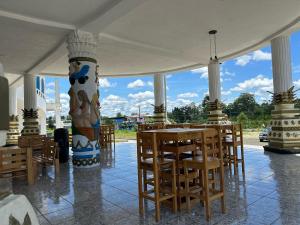 a room with a table and chairs and a pillar at Hotel Palace in La Concordia