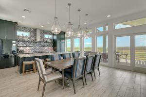 a kitchen and dining room with a table and chairs at BeachHouse Bliss in Padre Island +44 photos