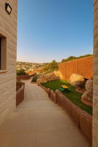 a courtyard with rocks and a bench on a building at Jordan Castle Resort in Irbid