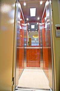 an elevator leading to a hallway with a door at Pioneer Excelsior Rooms in Paralia Katerinis