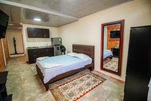 a bedroom with a bed and a mirror at Green Apartment el prado in Girón