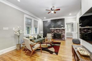 a living room with a couch and a fireplace at Hilltop retreat - Large pool in Woodlawn