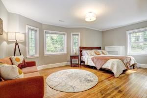 a bedroom with a bed and a couch and windows at Hilltop retreat - Large pool in Woodlawn +29 photos