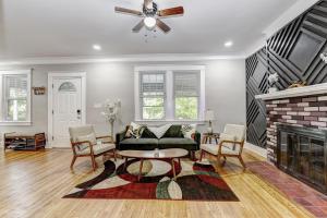 a living room with a couch and a fireplace at Hilltop retreat - Large pool in Woodlawn